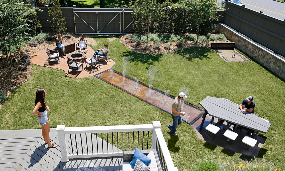 overhead photo of the NashVilla's large back yard with a fire pit, water features, and a picnic table that form the shape of a guitar